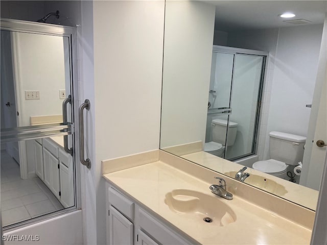 full bathroom featuring tile patterned flooring, vanity, enclosed tub / shower combo, and toilet