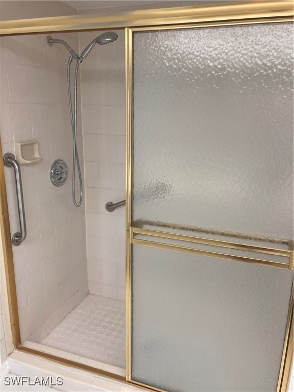 bathroom with a shower with door