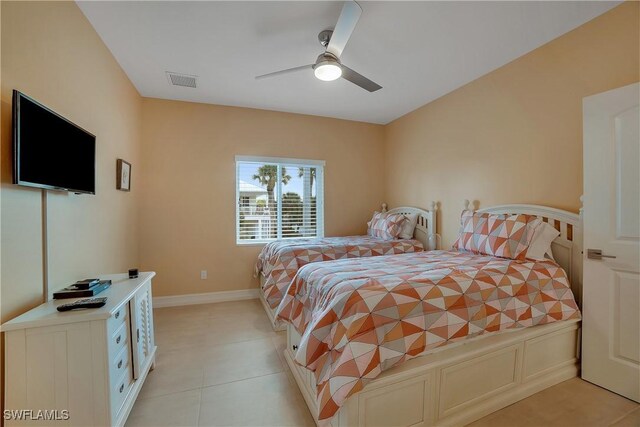 bedroom featuring a ceiling fan, visible vents, baseboards, and light tile patterned floors