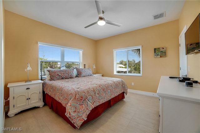 bedroom with visible vents, ceiling fan, baseboards, and multiple windows