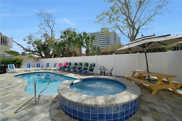 view of pool with an in ground hot tub, a patio area, a fenced backyard, and a fenced in pool