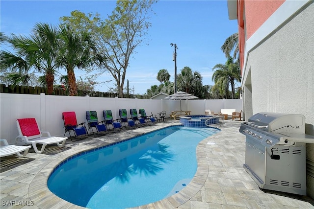 view of swimming pool featuring a pool with connected hot tub, a patio area, a fenced backyard, and a grill