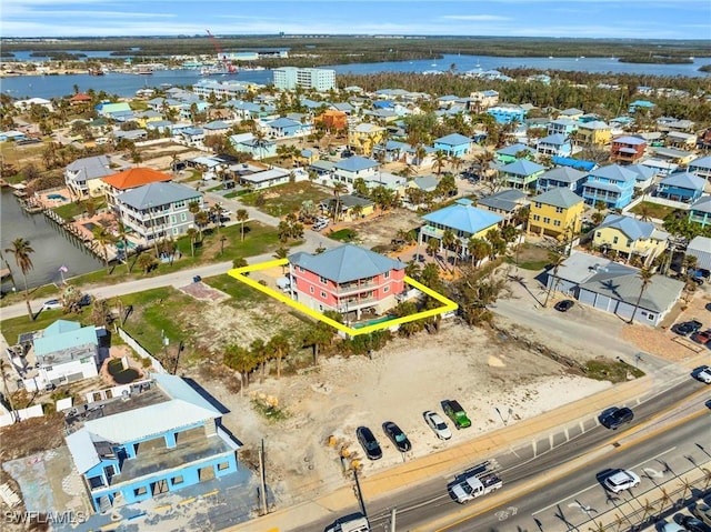 birds eye view of property with a water view and a residential view