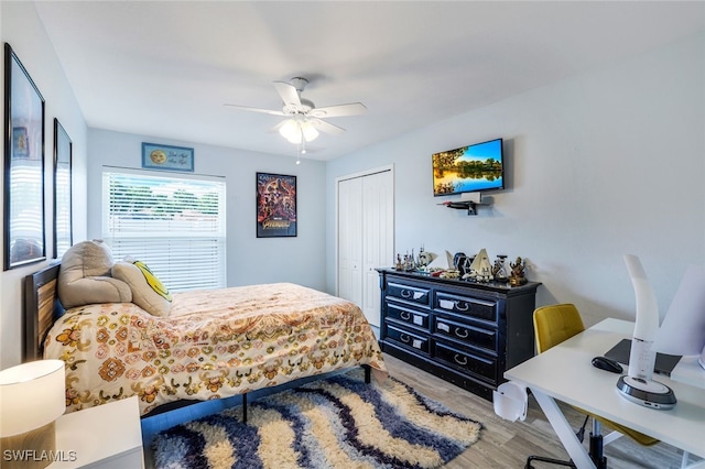 bedroom with ceiling fan, a closet, and wood finished floors