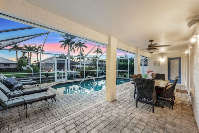 exterior space featuring a ceiling fan, a lanai, and an outdoor pool