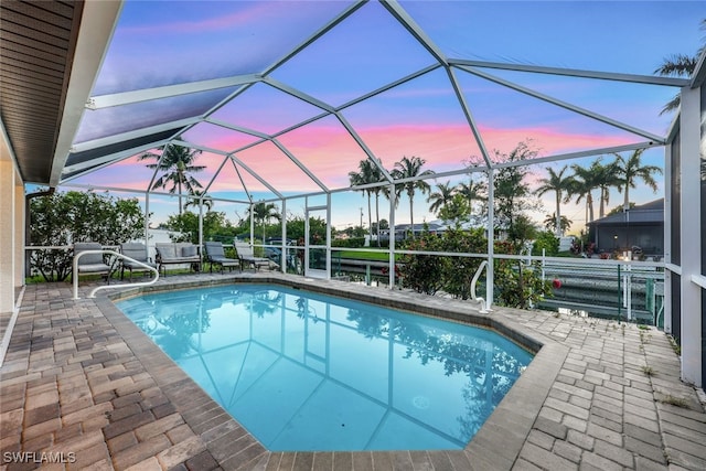 pool featuring a patio area and glass enclosure