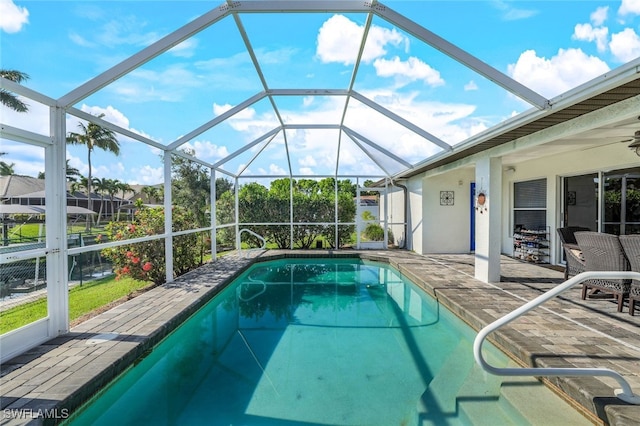 pool with a lanai and a patio area