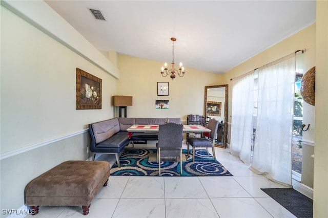 dining area featuring vaulted ceiling, marble finish floor, visible vents, and a notable chandelier