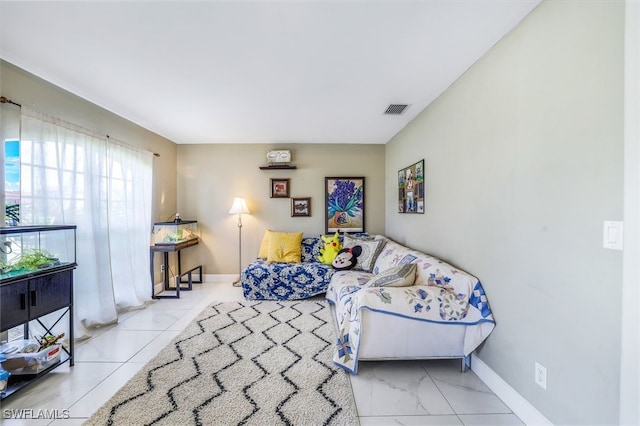 living area with visible vents and baseboards