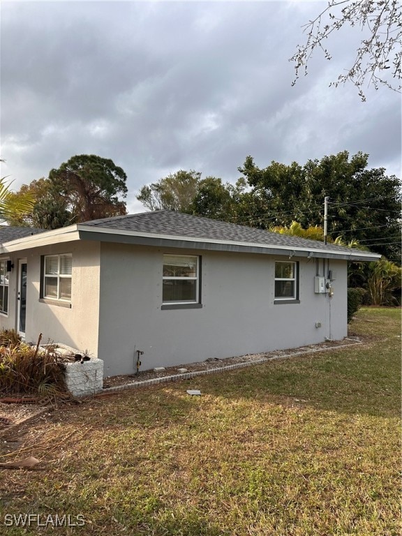 view of side of property with a yard