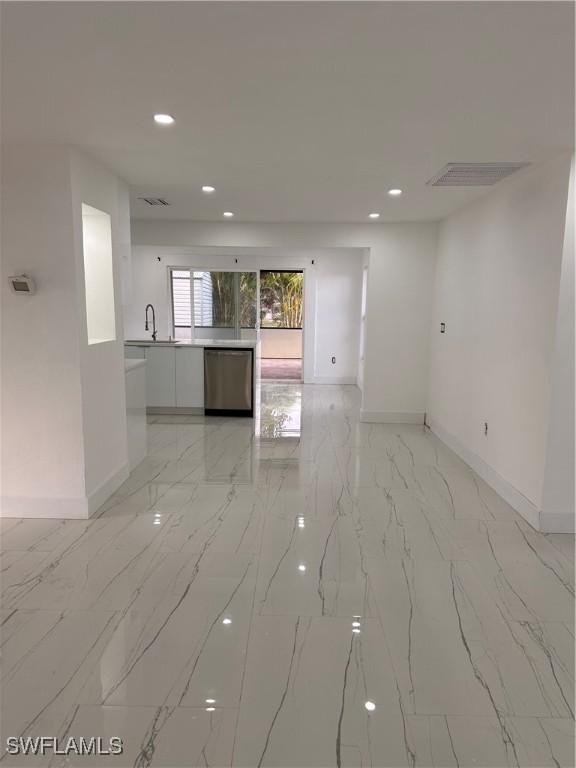 4562 Tennyson Dr, North Fort Myers, FL 33903 - unfurnished room featuring light marble finish floors and recessed lighting