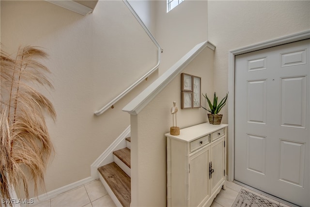 stairway with tile patterned flooring