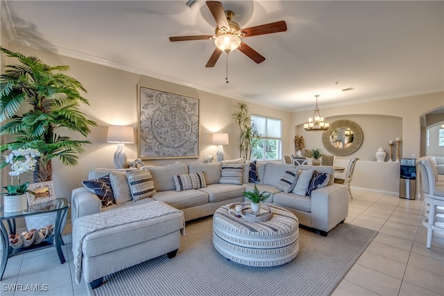 living room with ceiling fan with notable chandelier, light tile patterned flooring, and crown molding