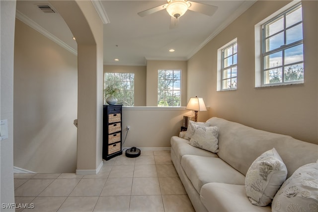 tiled living room featuring ornamental molding and ceiling fan