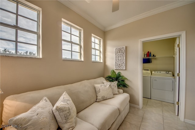 living room with ceiling fan, washer and clothes dryer, crown molding, and light tile patterned flooring