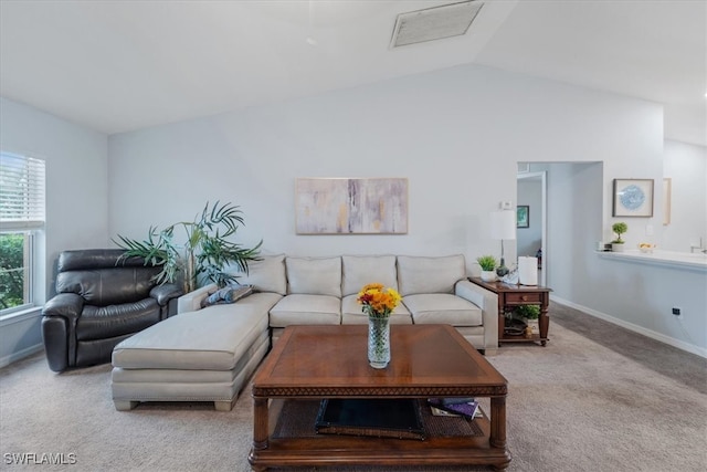 living room featuring lofted ceiling and light colored carpet