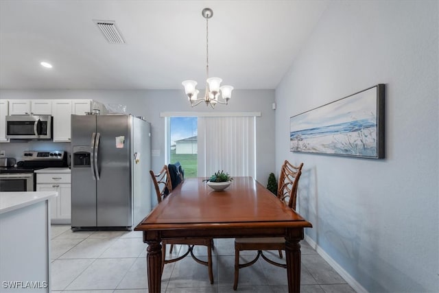 dining room featuring light tile patterned floors and an inviting chandelier