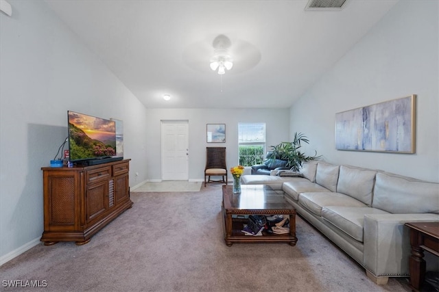 carpeted living room featuring ceiling fan and vaulted ceiling