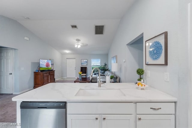 kitchen featuring light carpet, light stone countertops, sink, vaulted ceiling, and dishwasher