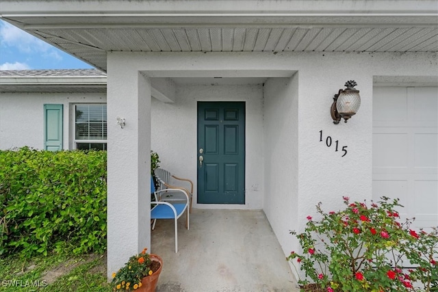 view of exterior entry with a garage