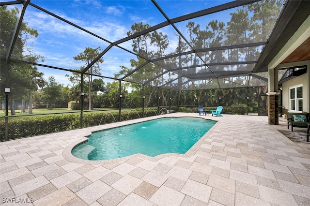 view of swimming pool featuring pool water feature, a lanai, and a patio