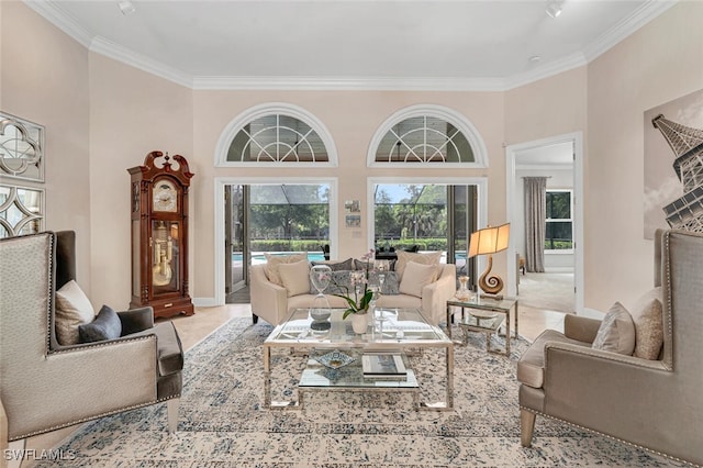 living room with a towering ceiling and ornamental molding