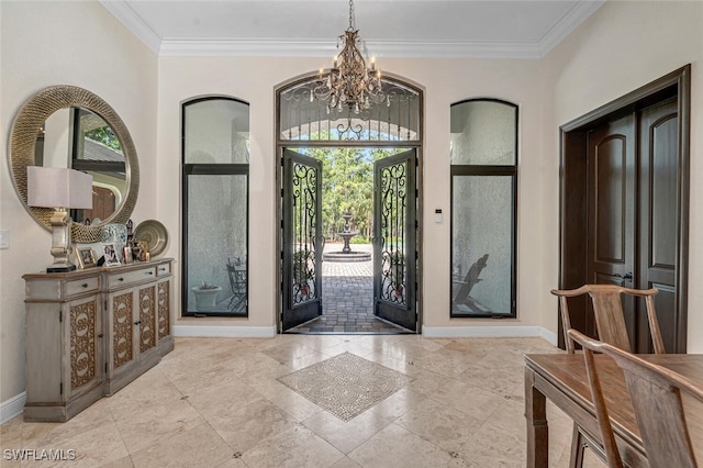 entryway with a chandelier, ornamental molding, a wealth of natural light, and french doors