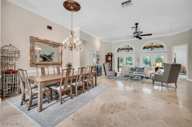 dining room with french doors, ceiling fan with notable chandelier, and ornamental molding