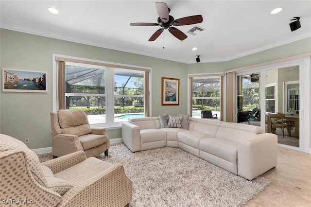 living room with ceiling fan and crown molding