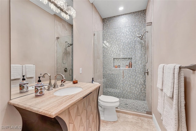 bathroom with tile patterned flooring, vanity, toilet, and walk in shower