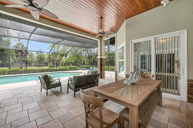 view of patio / terrace with ceiling fan and glass enclosure