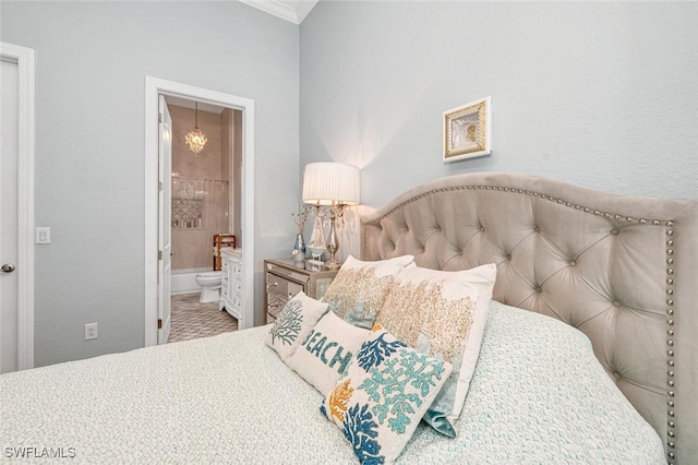 carpeted bedroom featuring crown molding and ensuite bath