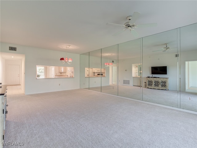 unfurnished bedroom with carpet floors, visible vents, and ceiling fan