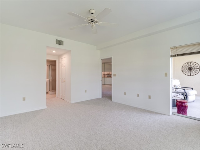 unfurnished bedroom featuring light colored carpet, visible vents, and baseboards