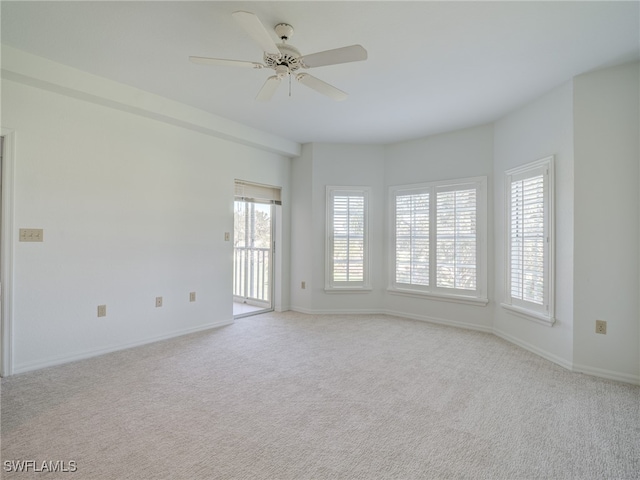 spare room with carpet, baseboards, and ceiling fan