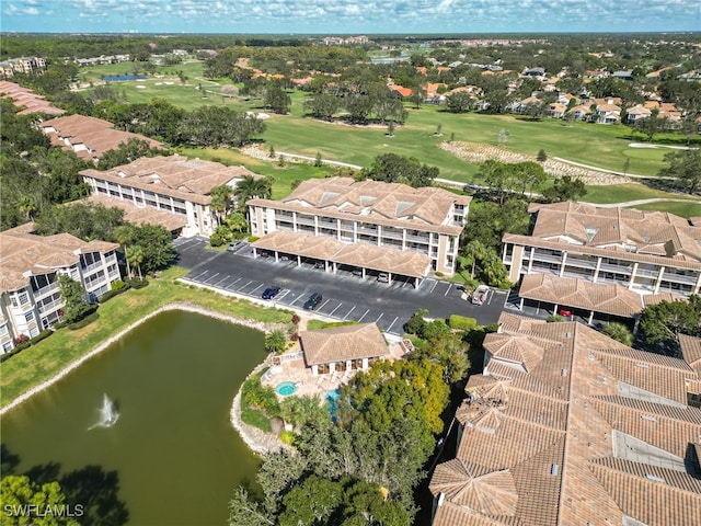 aerial view featuring a residential view, view of golf course, and a water view