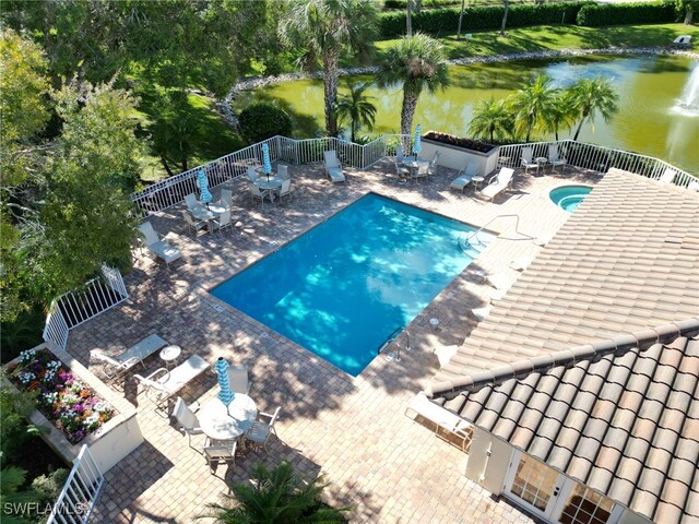 view of pool featuring a patio and a water view