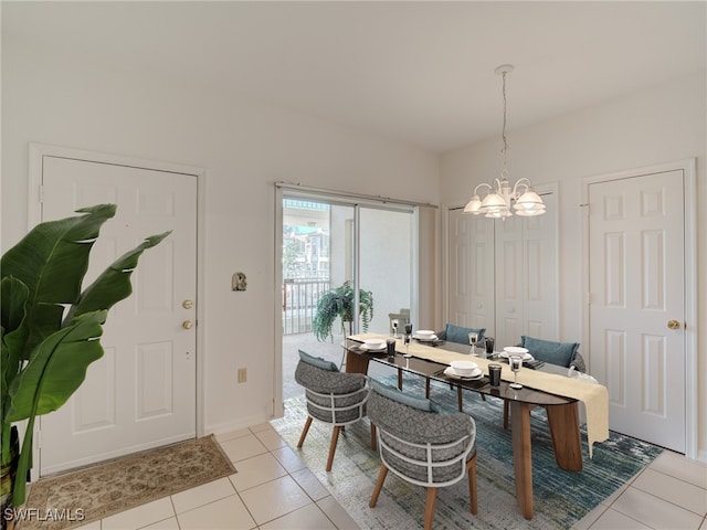 dining space with an inviting chandelier and light tile patterned floors