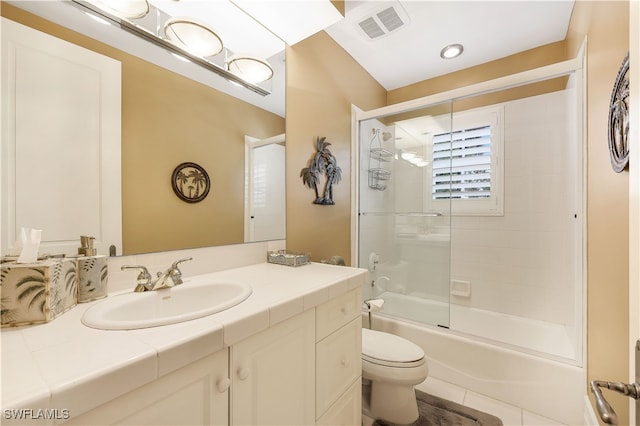 full bathroom with combined bath / shower with glass door, vanity, tile patterned floors, and toilet