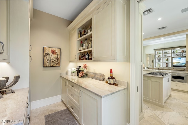 bar featuring light stone counters, white cabinets, stainless steel gas cooktop, and light tile patterned flooring