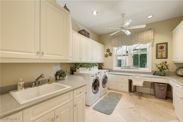 clothes washing area featuring sink, washing machine and clothes dryer, cabinets, ceiling fan, and light tile patterned floors