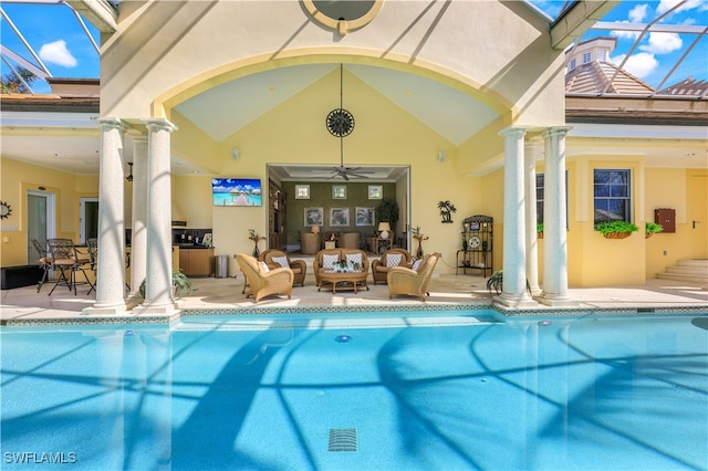 view of swimming pool featuring a lanai, ceiling fan, outdoor lounge area, and a patio area