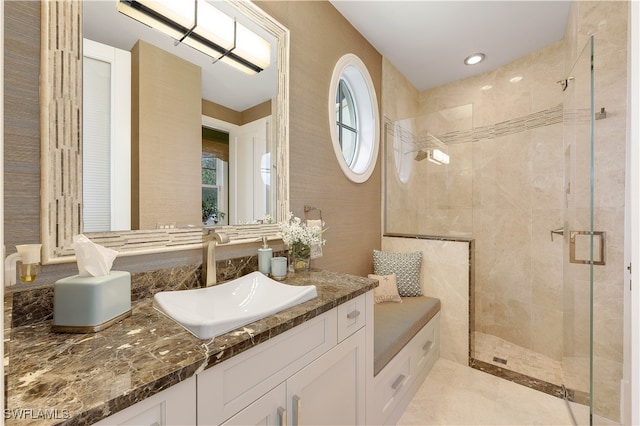 bathroom with vanity and a shower with shower door