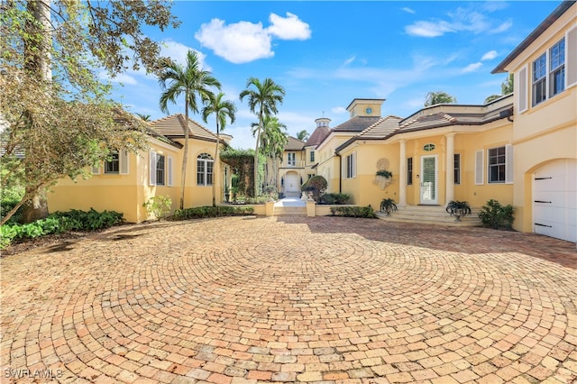 mediterranean / spanish-style house with a garage