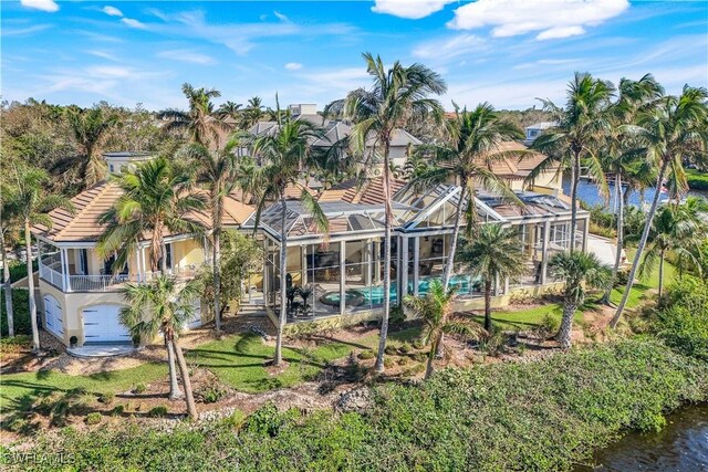 exterior space with glass enclosure and a water view