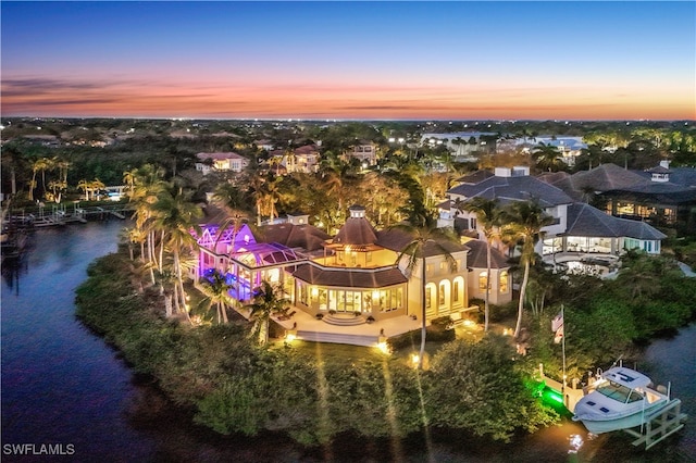 aerial view at dusk with a water view