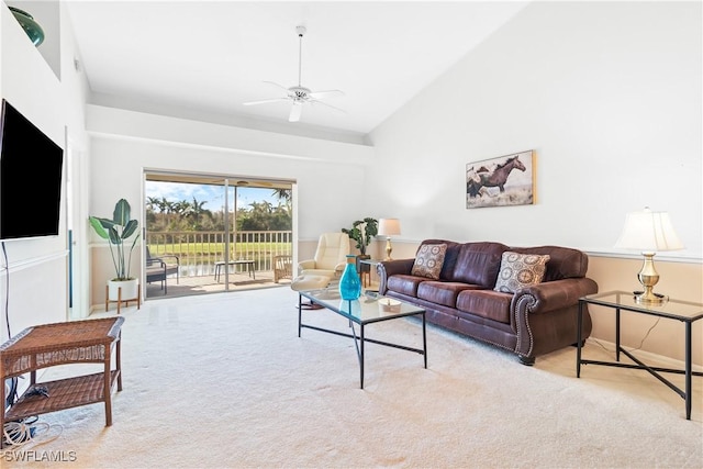 living room featuring ceiling fan, light colored carpet, and vaulted ceiling