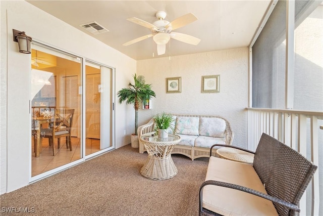 sunroom / solarium featuring ceiling fan