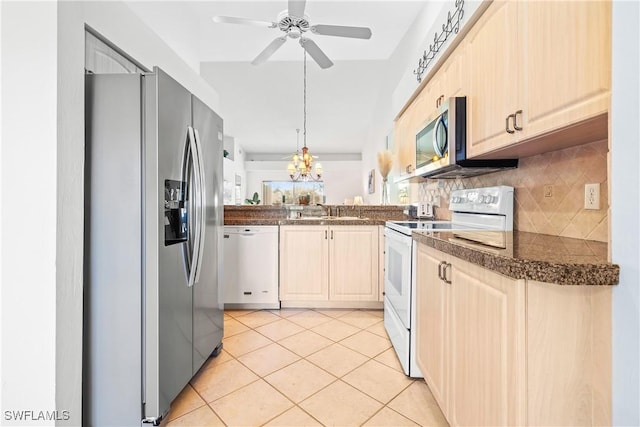 kitchen with ceiling fan, sink, stainless steel appliances, backsplash, and light tile patterned flooring