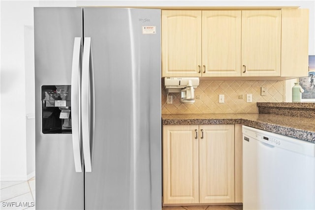 kitchen featuring light brown cabinets, stainless steel fridge with ice dispenser, backsplash, white dishwasher, and light tile patterned floors